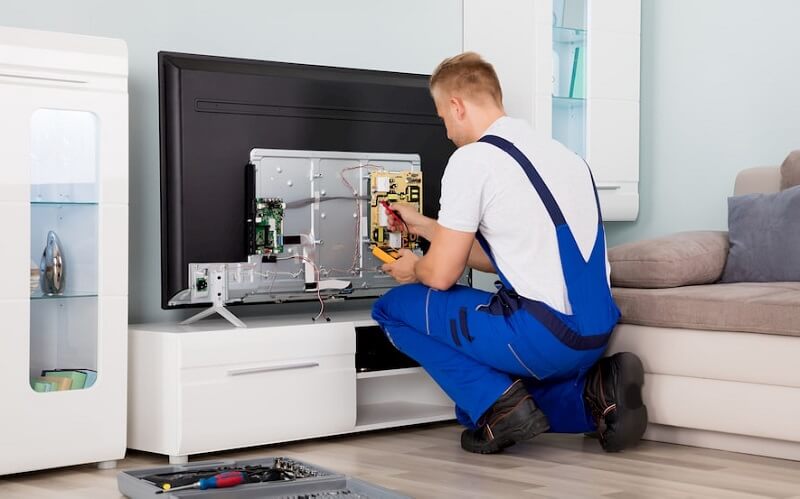 Мастер ремонтирует телевизор
